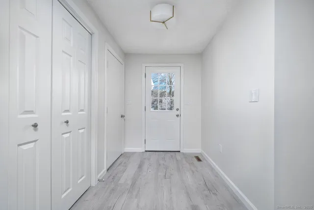 a view of an empty room with wooden floor