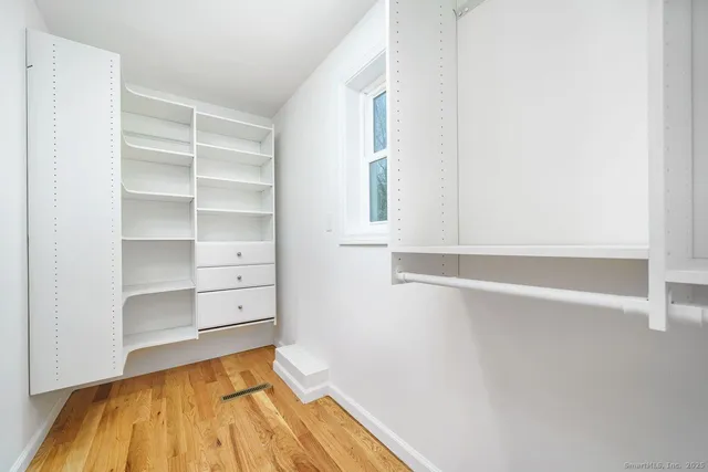 a view of walk in closet with empty racks