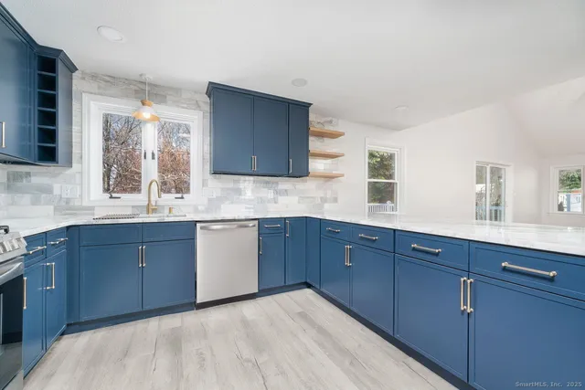 a kitchen with stainless steel appliances granite countertop wooden cabinets a sink and dishwasher