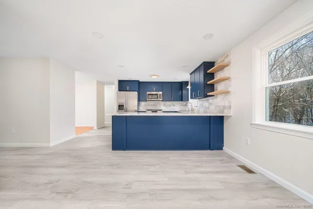 a kitchen with stainless steel appliances cabinets a sink and a window