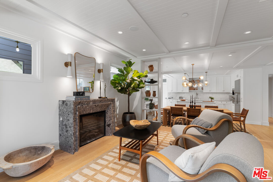 929 Marco Place Venice, CA 90291 - Photo 20 of 56 a living room with furniture potted plant and a fireplace