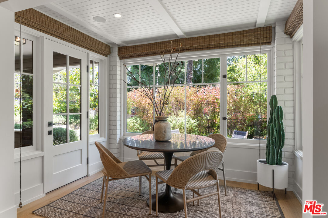 929 Marco Place Venice, CA 90291 - Photo 21 of 56 a dining room with furniture wooden floor and a potted plant