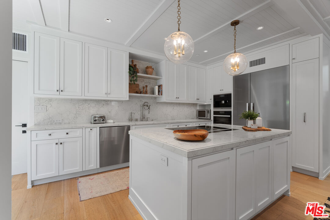 929 Marco Place Venice, CA 90291 - Photo 29 of 56 a kitchen with cabinets and stainless steel appliances