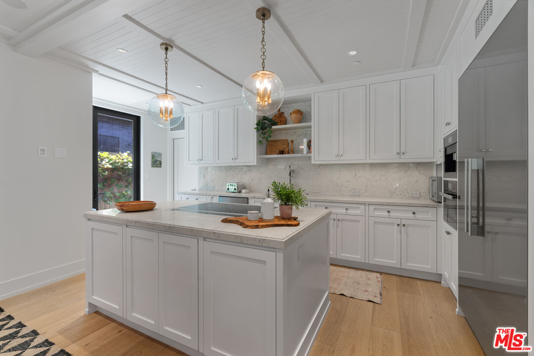 929 Marco Place Venice, CA 90291 - Photo 30 of 56 a kitchen with stainless steel appliances granite countertop a lot of counter space and wooden floors