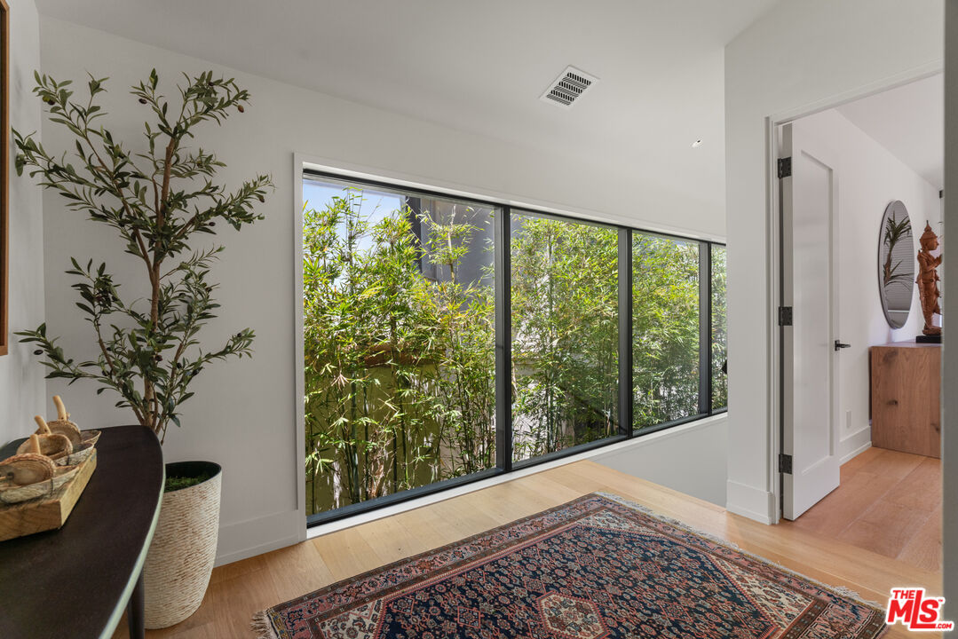 929 Marco Place Venice, CA 90291 - Photo 37 of 56 a view of a porch with a floor to ceiling window and a potted plant