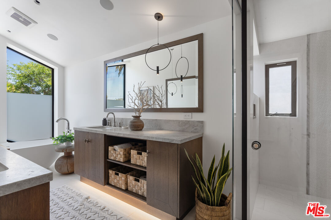 929 Marco Place Venice, CA 90291 - Photo 44 of 56 a view of a bathroom with a sink and a mirror