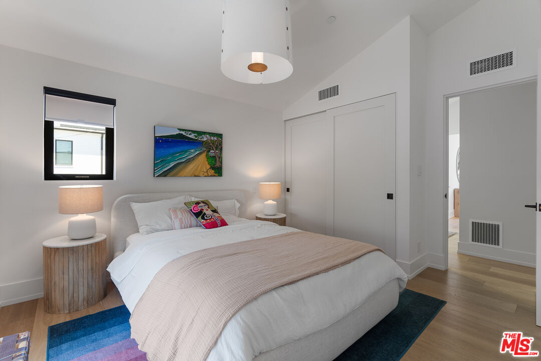 929 Marco Place Venice, CA 90291 - Photo 48 of 56 a bedroom with a bed and a wooden floor