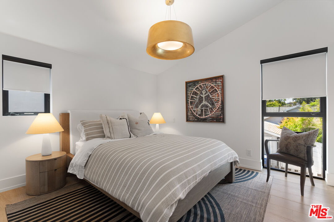 929 Marco Place Venice, CA 90291 - Photo 50 of 56 a bedroom with a bed and painting on the wall