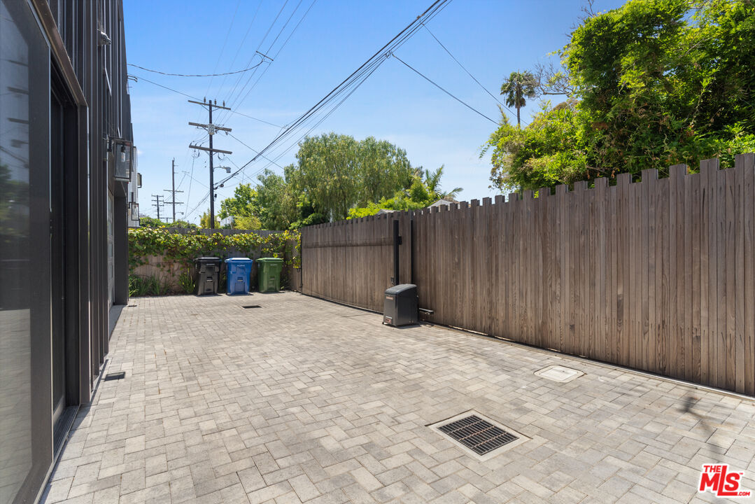 929 Marco Place Venice, CA 90291 - Photo 56 of 56 a backyard of a house with plants and trees with wooden fence