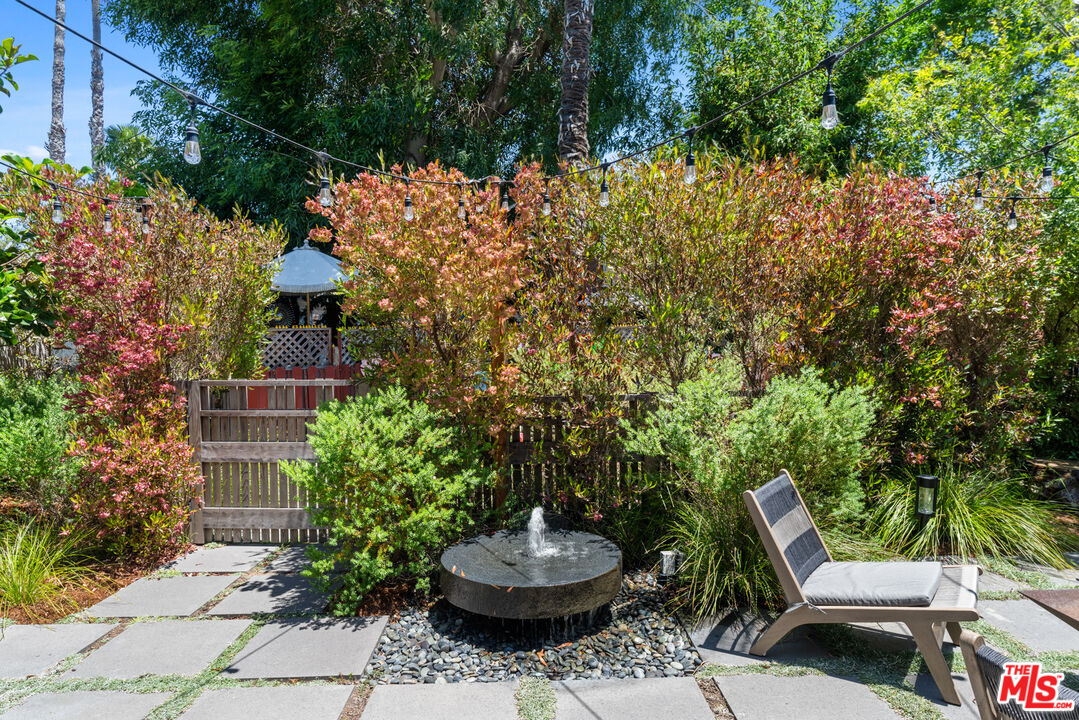 929 Marco Place Venice, CA 90291 - Photo 10 of 56 a backyard with table and chairs and potted plants