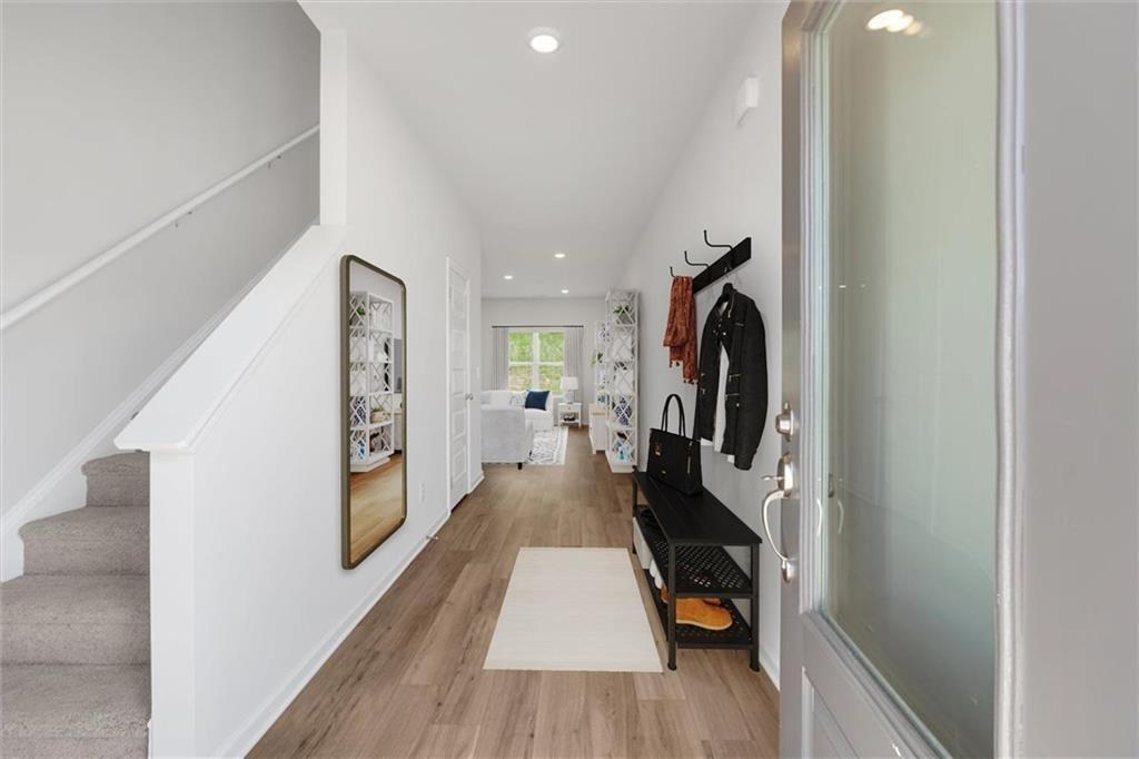 107 Lavender Circle Calhoun, GA 30701 - Photo 4 of 32 a hallway with a wooden floor a washer and dryer