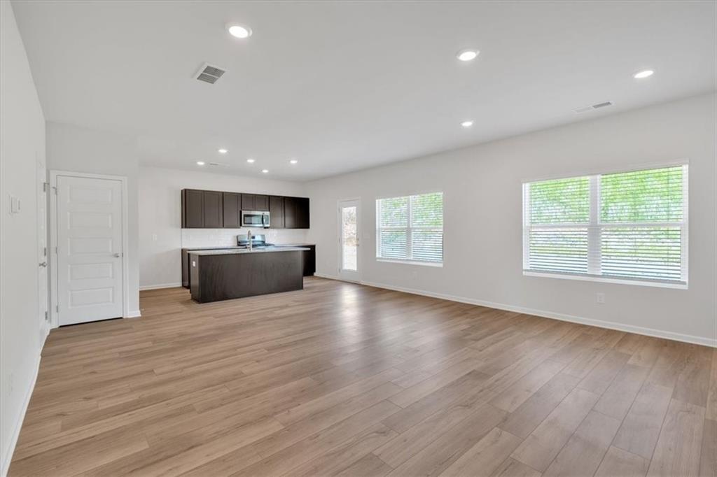 107 Lavender Circle Calhoun, GA 30701 - Photo 9 of 32 a view of kitchen and kitchen with furniture wooden floor and window