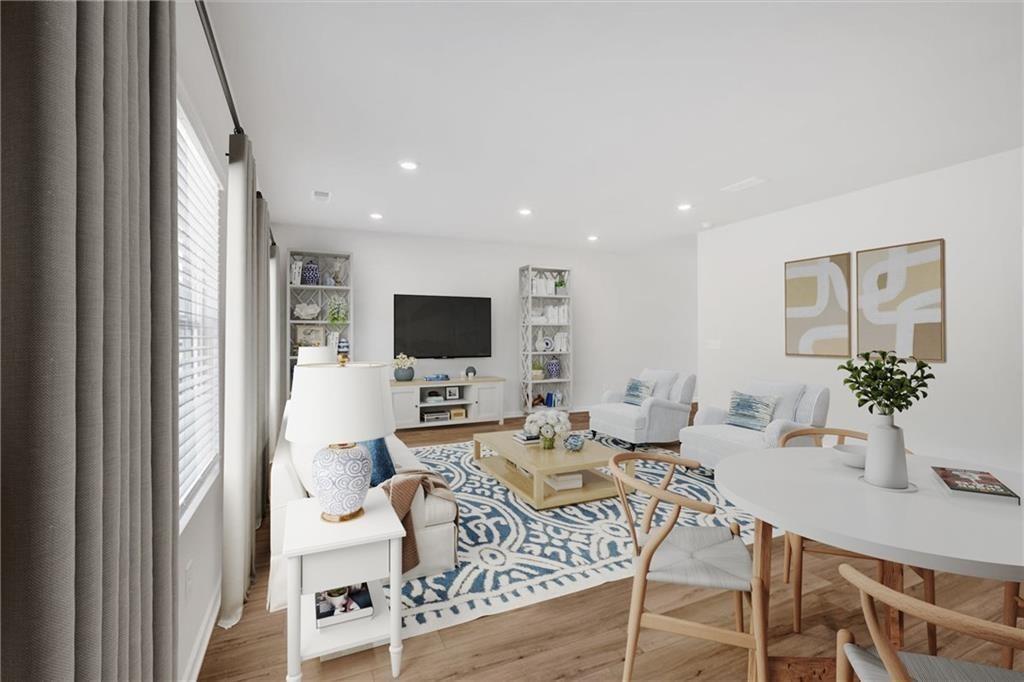 107 Lavender Circle Calhoun, GA 30701 - Photo 10 of 32 a living room with furniture a flat screen tv and a large window