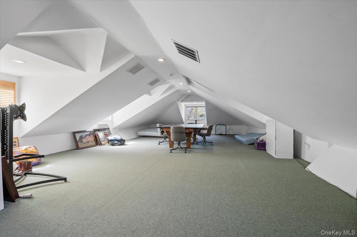 12 Ridge Court Glen Head, NY 11545 - Photo 32 of 46 Additional living space featuring carpet flooring, lofted ceiling, and recessed lighting