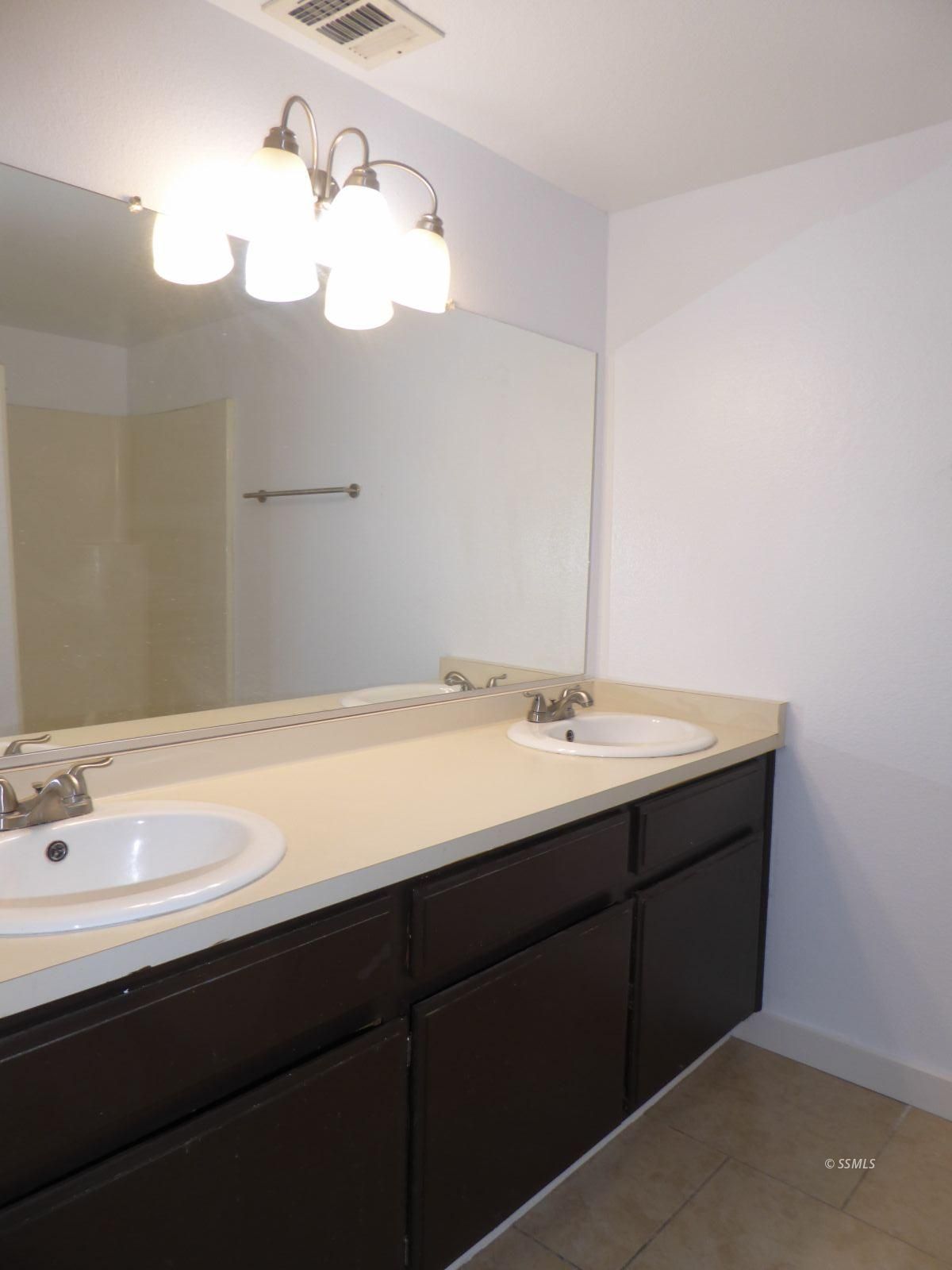 824 C Capehart Court Ridgecrest, CA 93555 - Photo 11 of 11 a bathroom with a sink vanity and a mirror