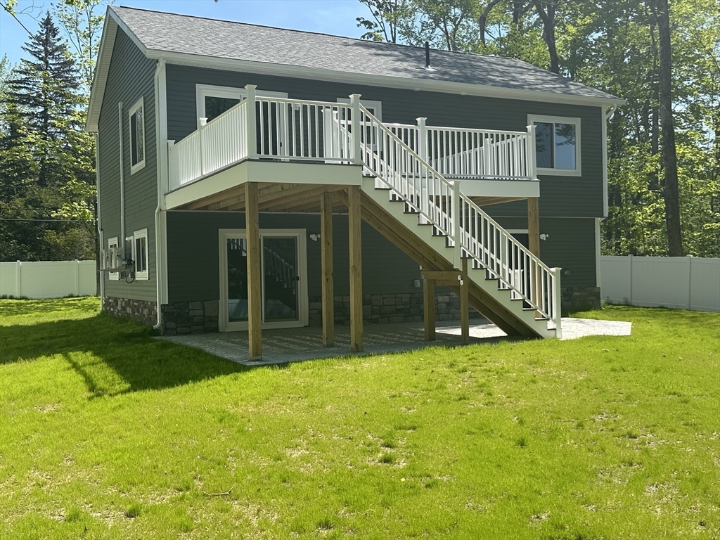 102 Wells Road Becket, MA 01223 - Photo 6 of 40 a view of a house with a yard and a large tree