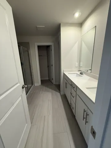 a spacious bathroom with a double vanity sink and a mirror