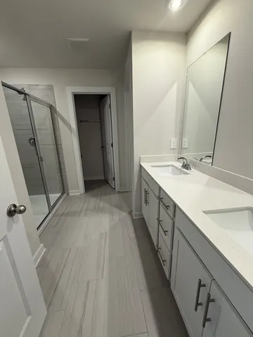 a spacious bathroom with a double vanity sink and a mirror