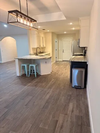 a view of kitchen with sink microwave and stove