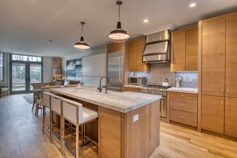 a kitchen with sink cabinets and wooden floor