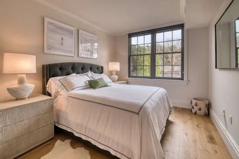 a bedroom with a bed and window