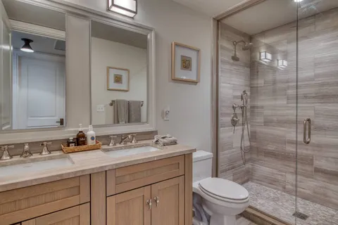 a bathroom with a sink toilet and shower