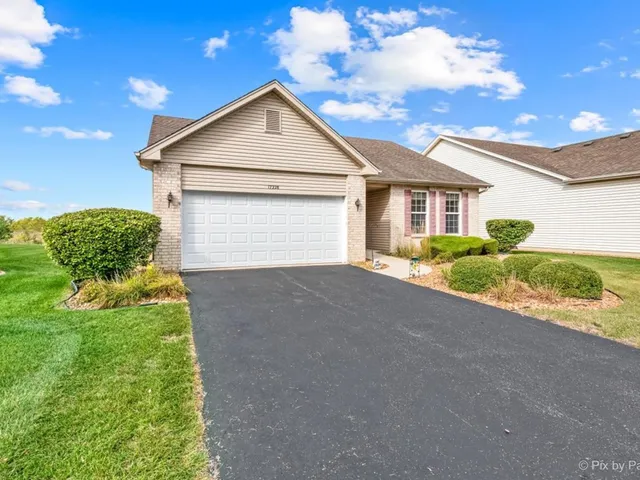 a view of a house with a yard and garage
