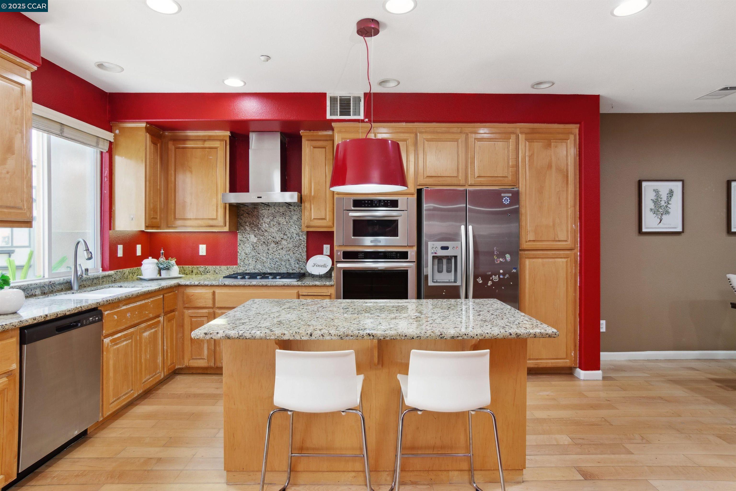 2073 Watermill Road San Ramon, CA 94582 - Photo 14 of 46 a kitchen with stainless steel appliances granite countertop a kitchen island and chairs in it