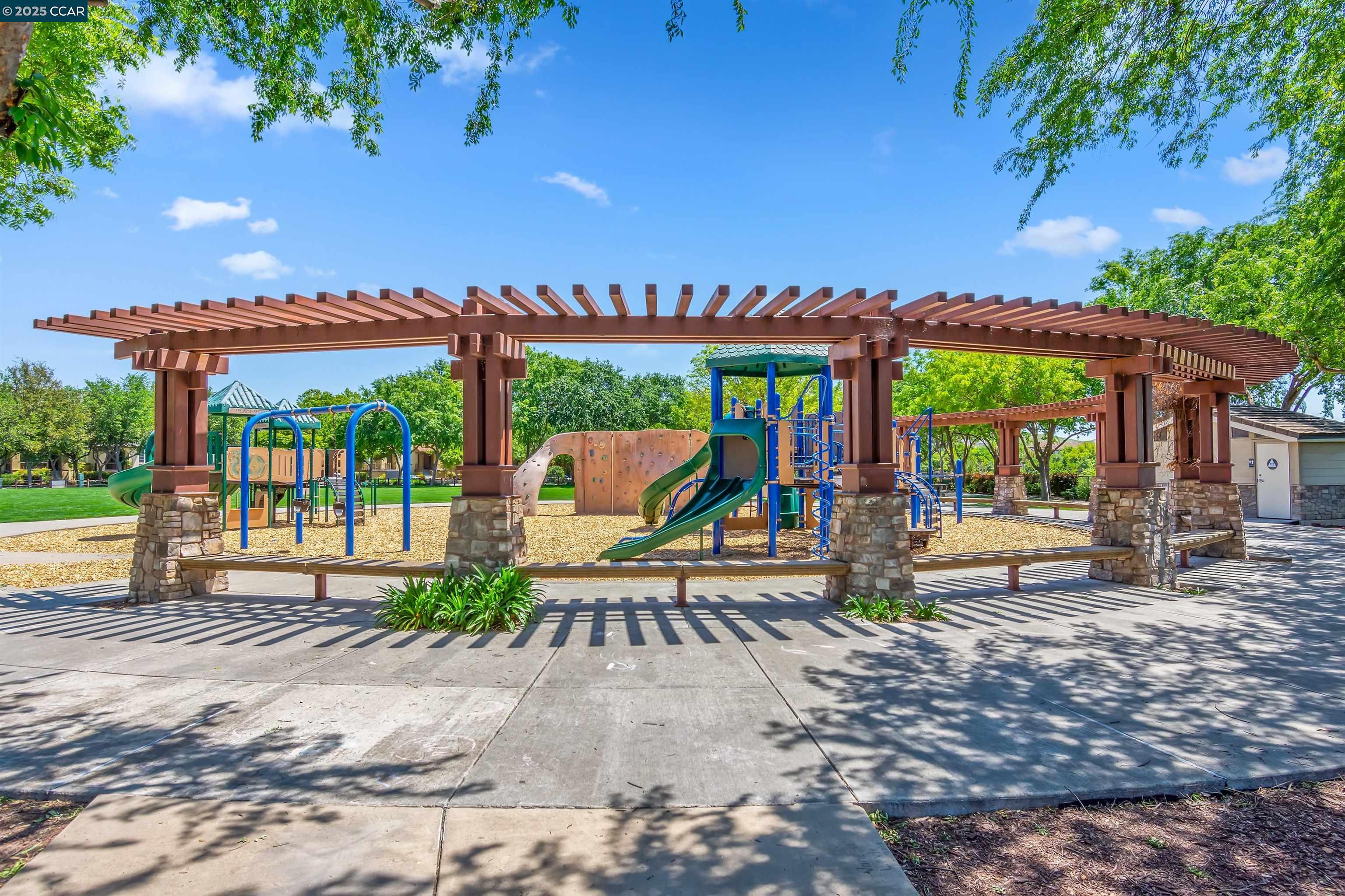 2073 Watermill Road San Ramon, CA 94582 - Photo 40 of 46 a patio with tables and chairs and a fire pit with large trees
