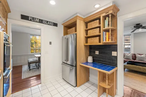a kitchen with stainless steel appliances granite countertop a refrigerator and a stove