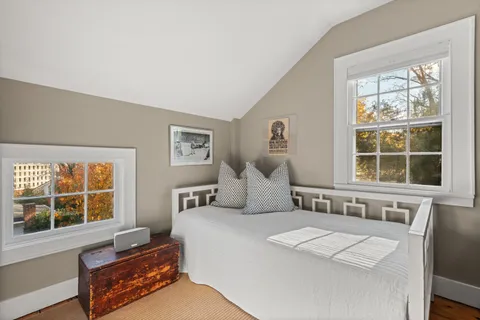 a bedroom with furniture and a window