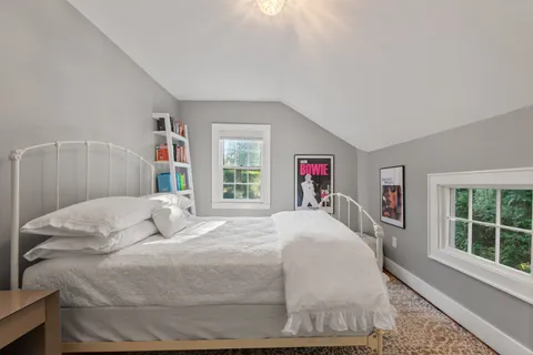 a bedroom with a large bed and a window