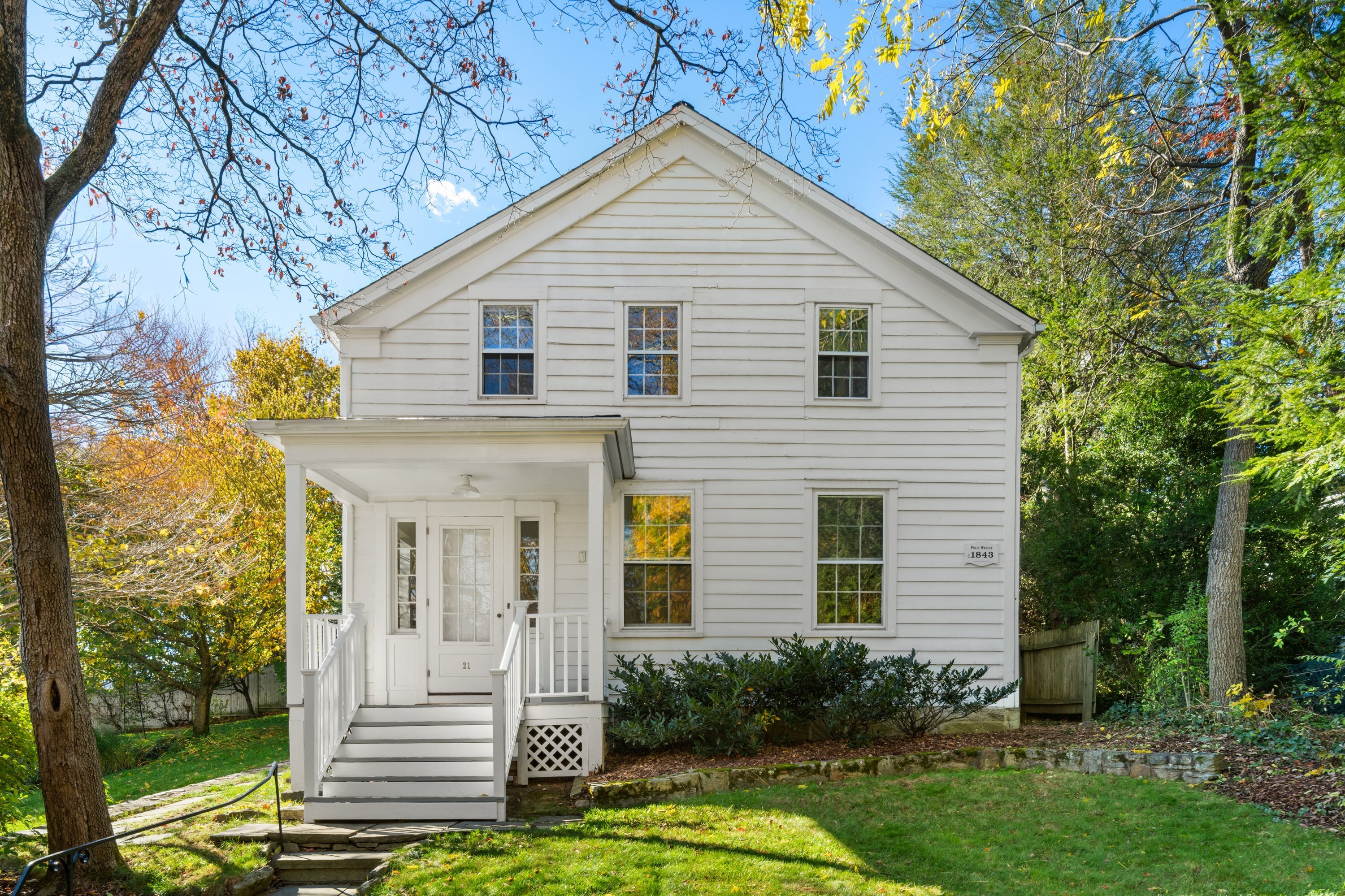 21 Wright Street Westport, CT 06880 - Photo 24 of 24 a view of a house with brick walls and flower plants next to a yard