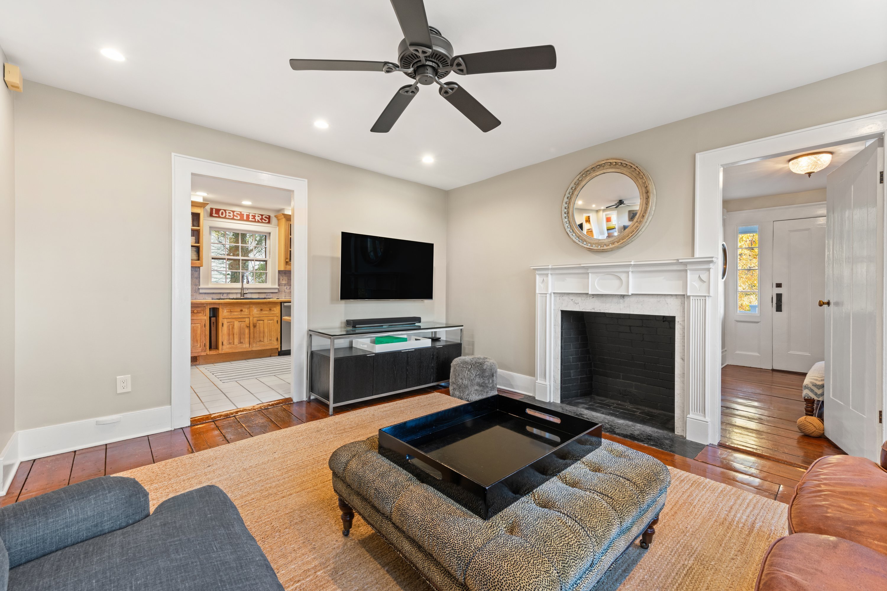 21 Wright Street Westport, CT 06880 - Photo 5 of 24 a living room with furniture a flat screen tv and a fireplace