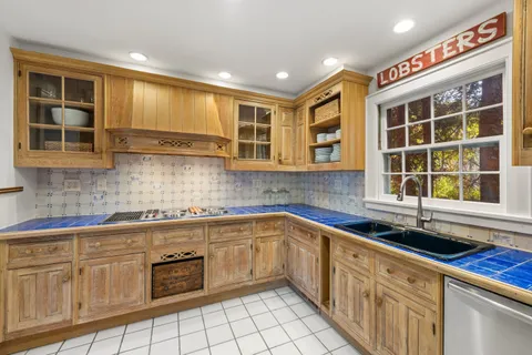a kitchen with a sink stove and cabinets