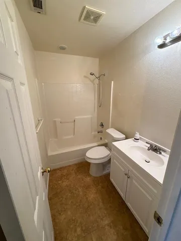 a bathroom with a double vanity sink toilet and shower