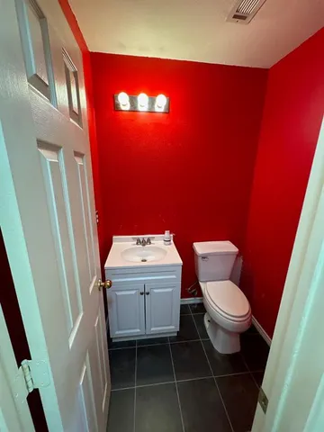 a bathroom with a sink a toilet and a mirror