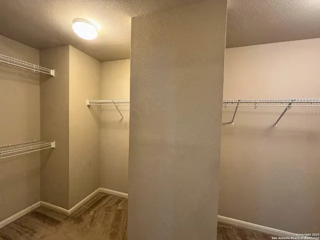 a spacious bathroom with a granite countertop sink and a mirror