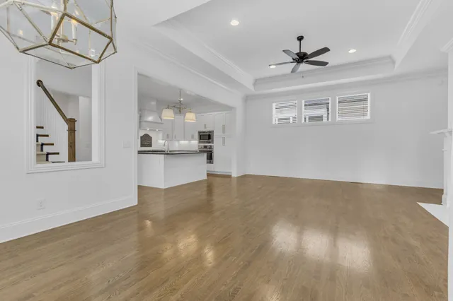 a view of a kitchen with a sink hardwood floor and a window