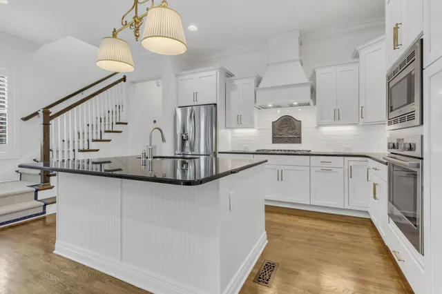 a kitchen with cabinets a sink and appliances