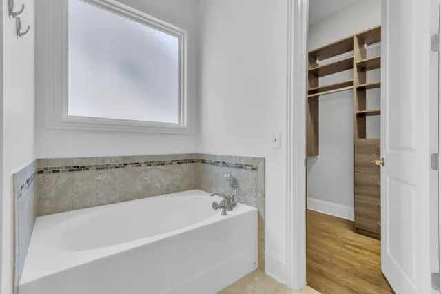 a white bath tub sitting next to a bathroom sink
