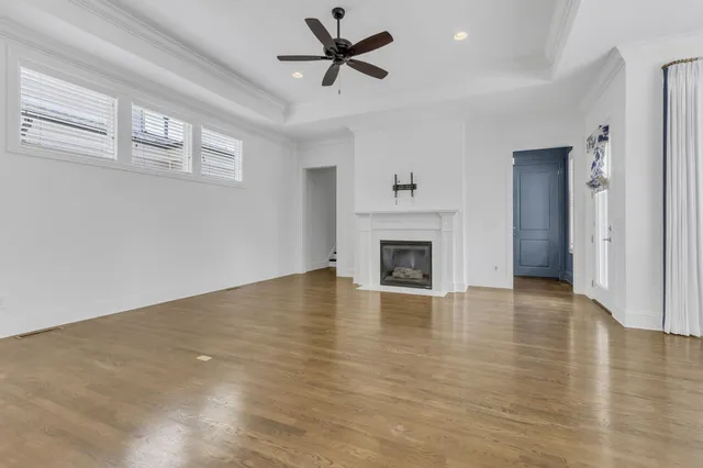 a view of empty room with wooden floor and fireplace