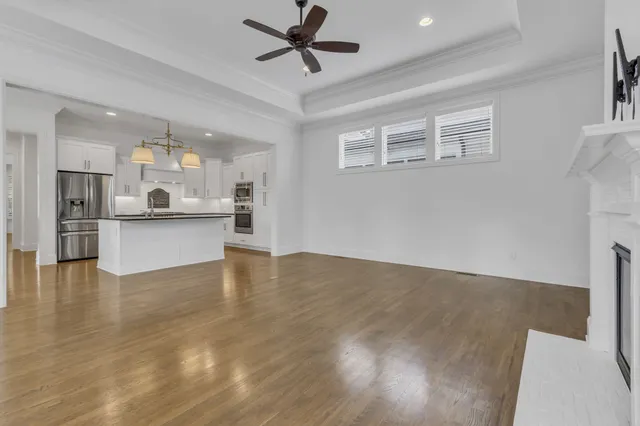 a view of a kitchen with wooden floor and a kitchen
