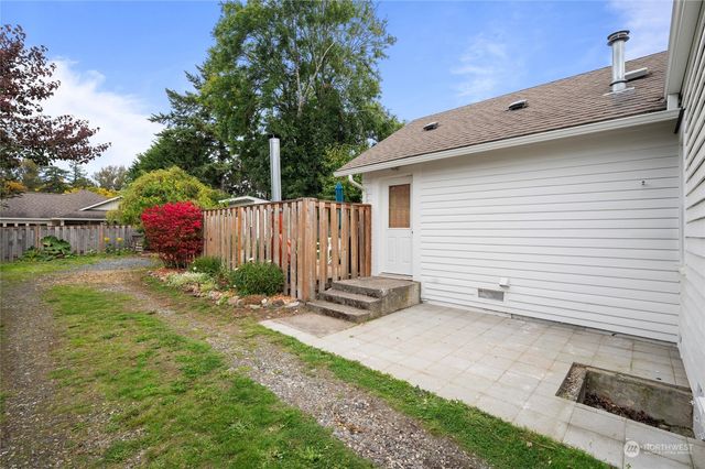 a view of a backyard with sitting area