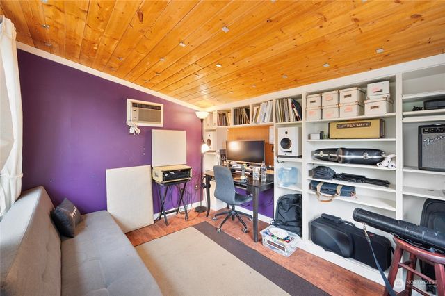 a bedroom with furniture and a flat screen tv