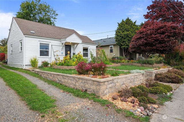 a front view of house with yard and green space