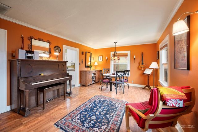 a living room with furniture a rug and a floor to ceiling window