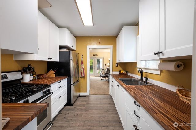 a kitchen with stainless steel appliances granite countertop a stove and a sink