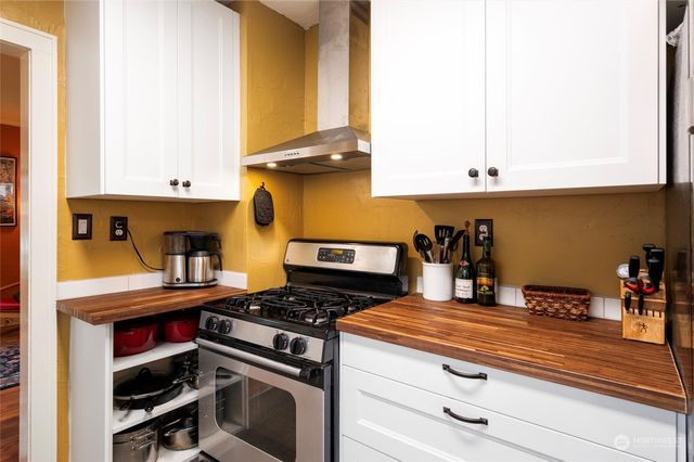 a kitchen with stove and cabinets