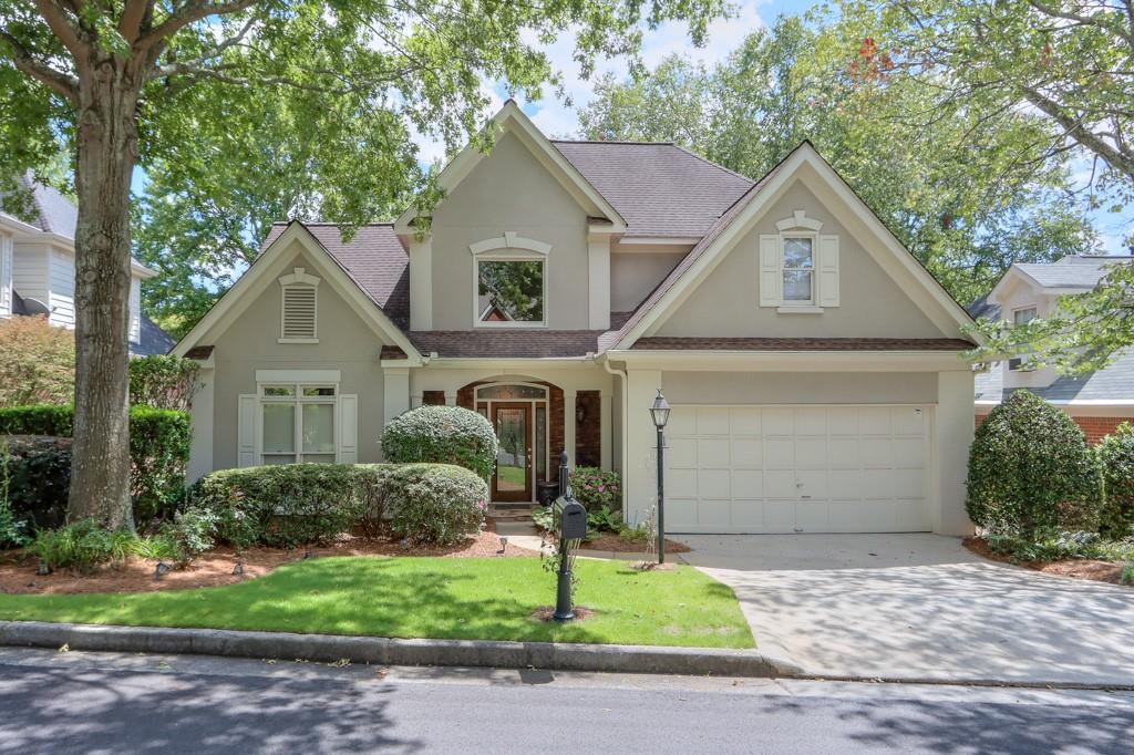 4567 Devonshire Road Atlanta, GA 30338 - Photo 1 of 1 a front view of a house with a yard and garage